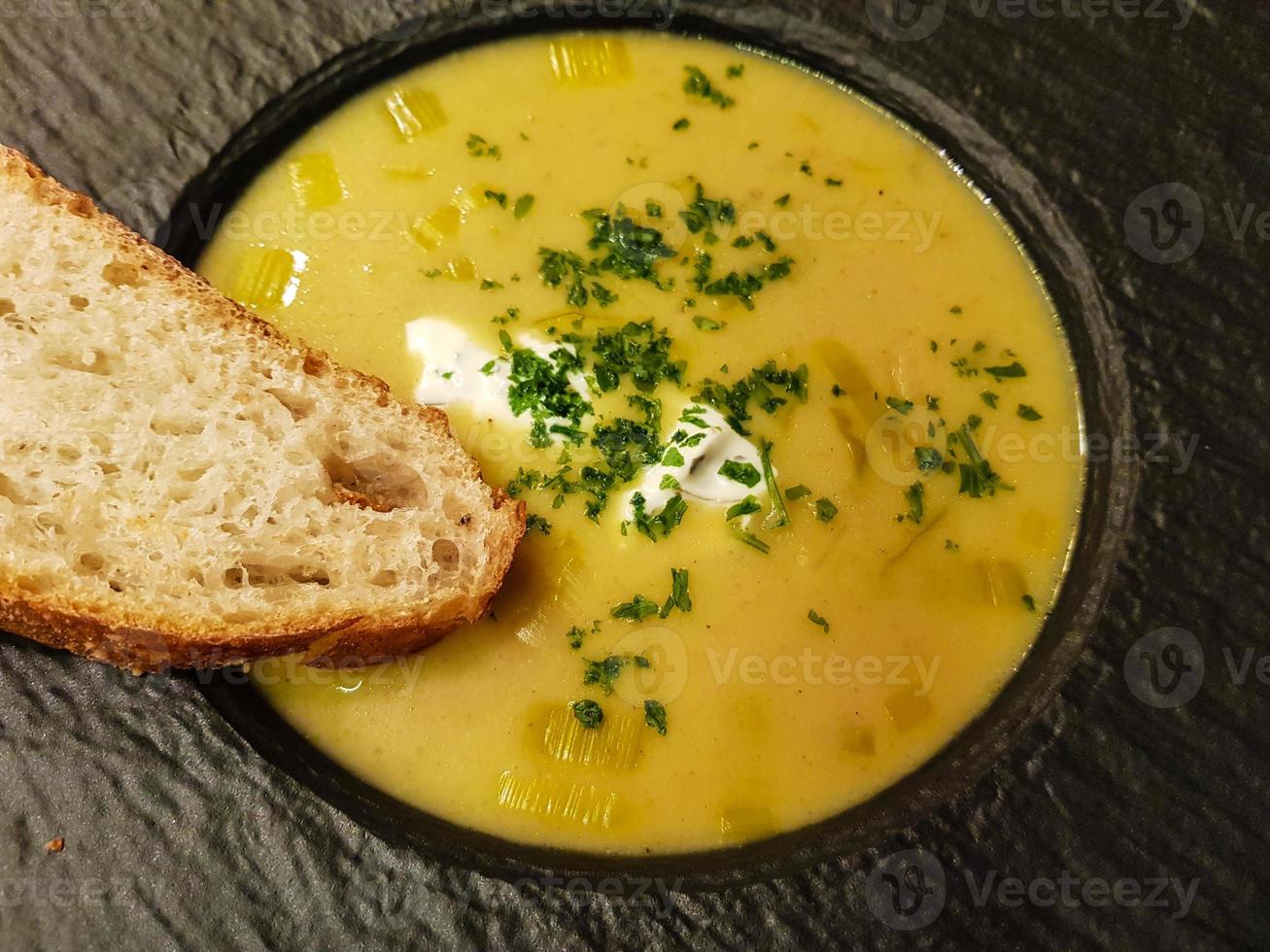 Spicy curry soup with bread photo