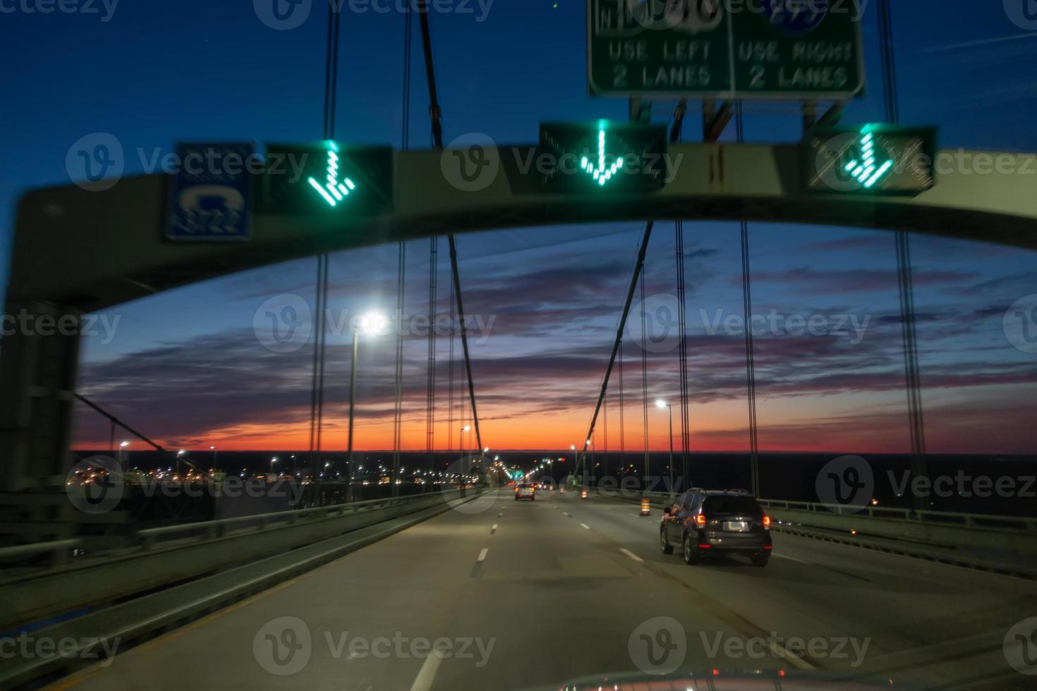 driving over a bridge early morning at sunriseac photo