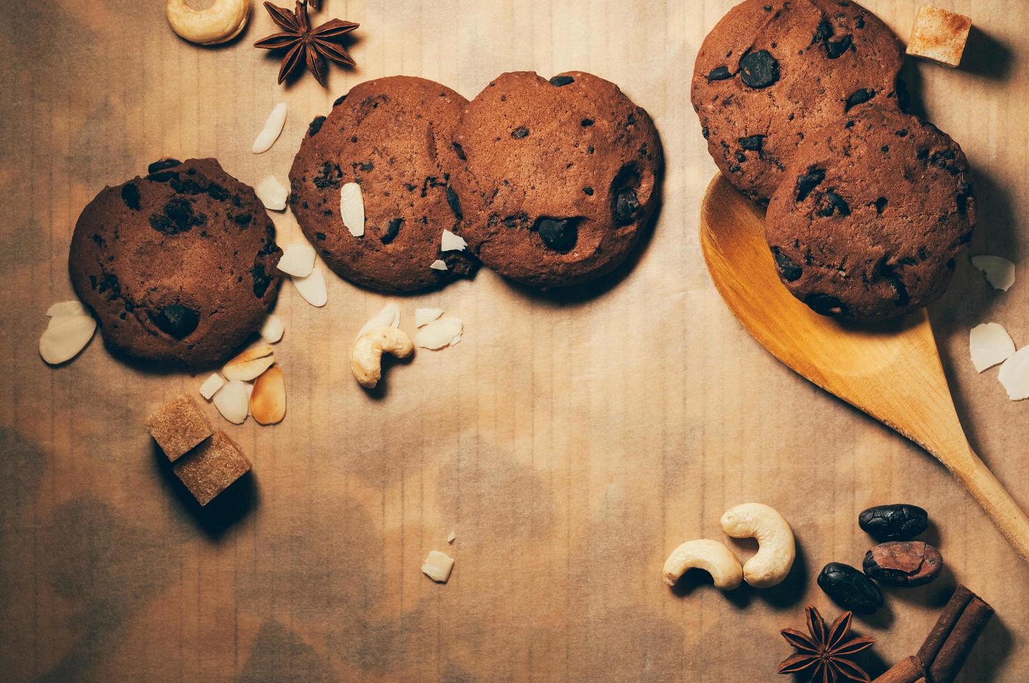 Round crispy chocolate cookies with spices and nuts on a table photo