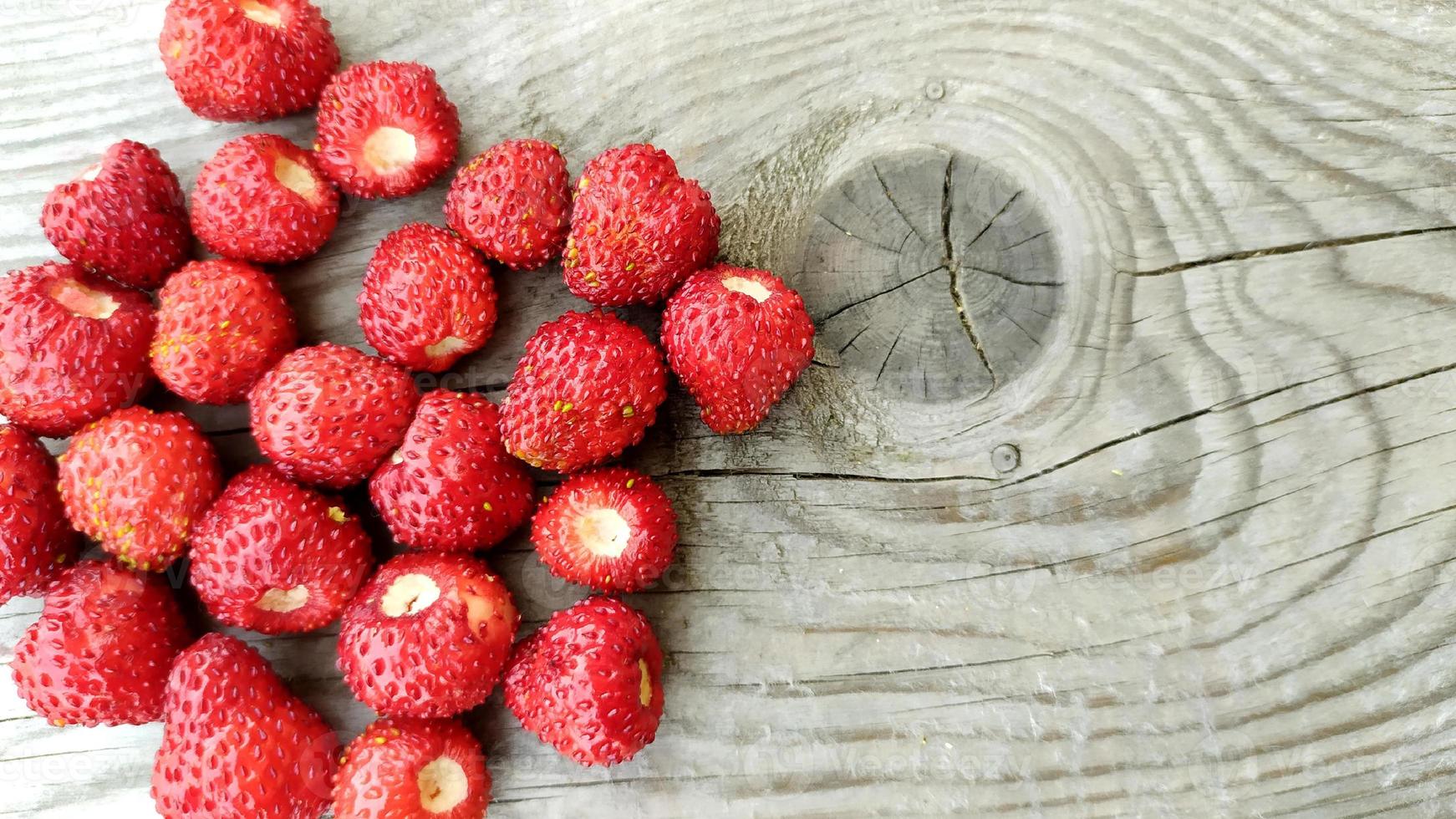 Strawberries on a wooden background. Ripe red berries lie photo