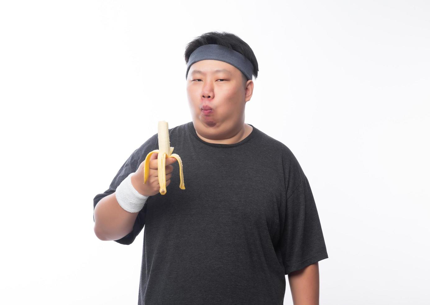 Young asian fat man eating banana photo
