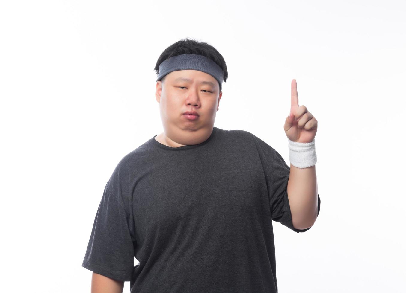 Young asian fat man pointing up photo