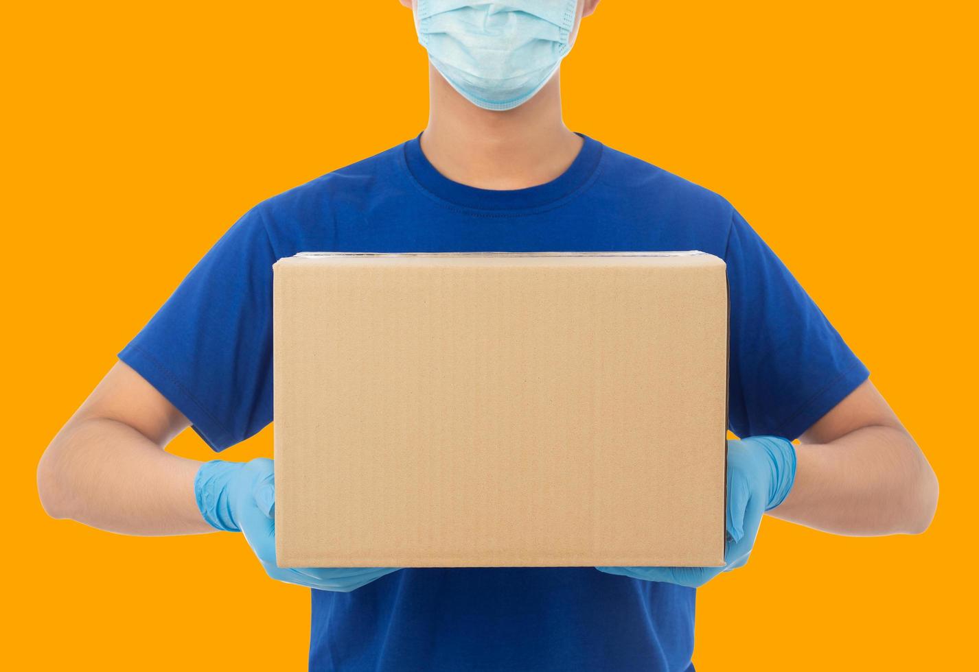 Delivery man wearing mask and holding the box photo