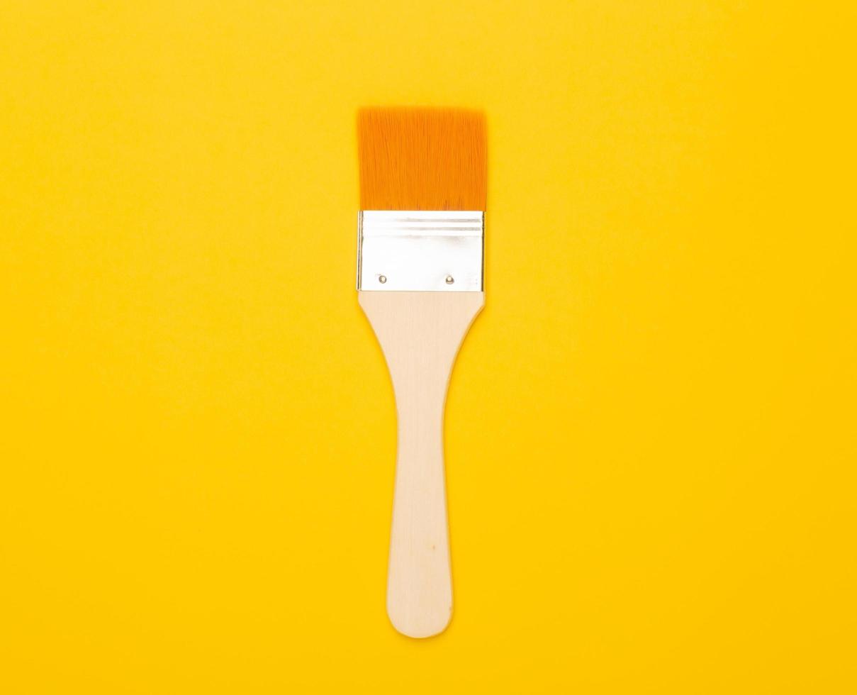 paintbrush isolated on yellow background photo