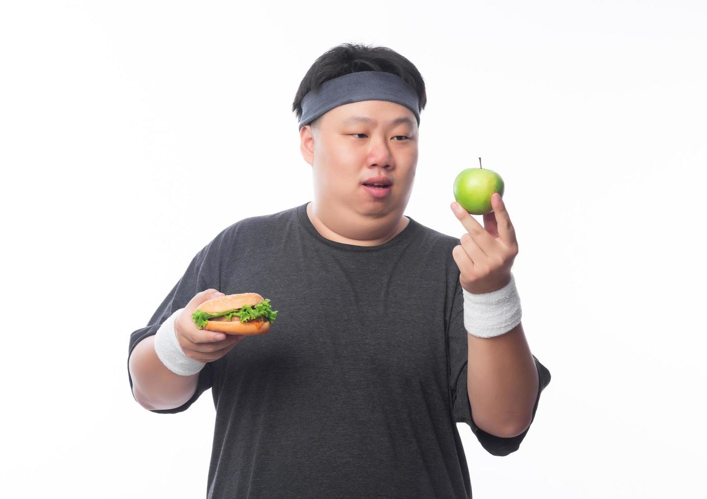Young fat man choose green apple photo