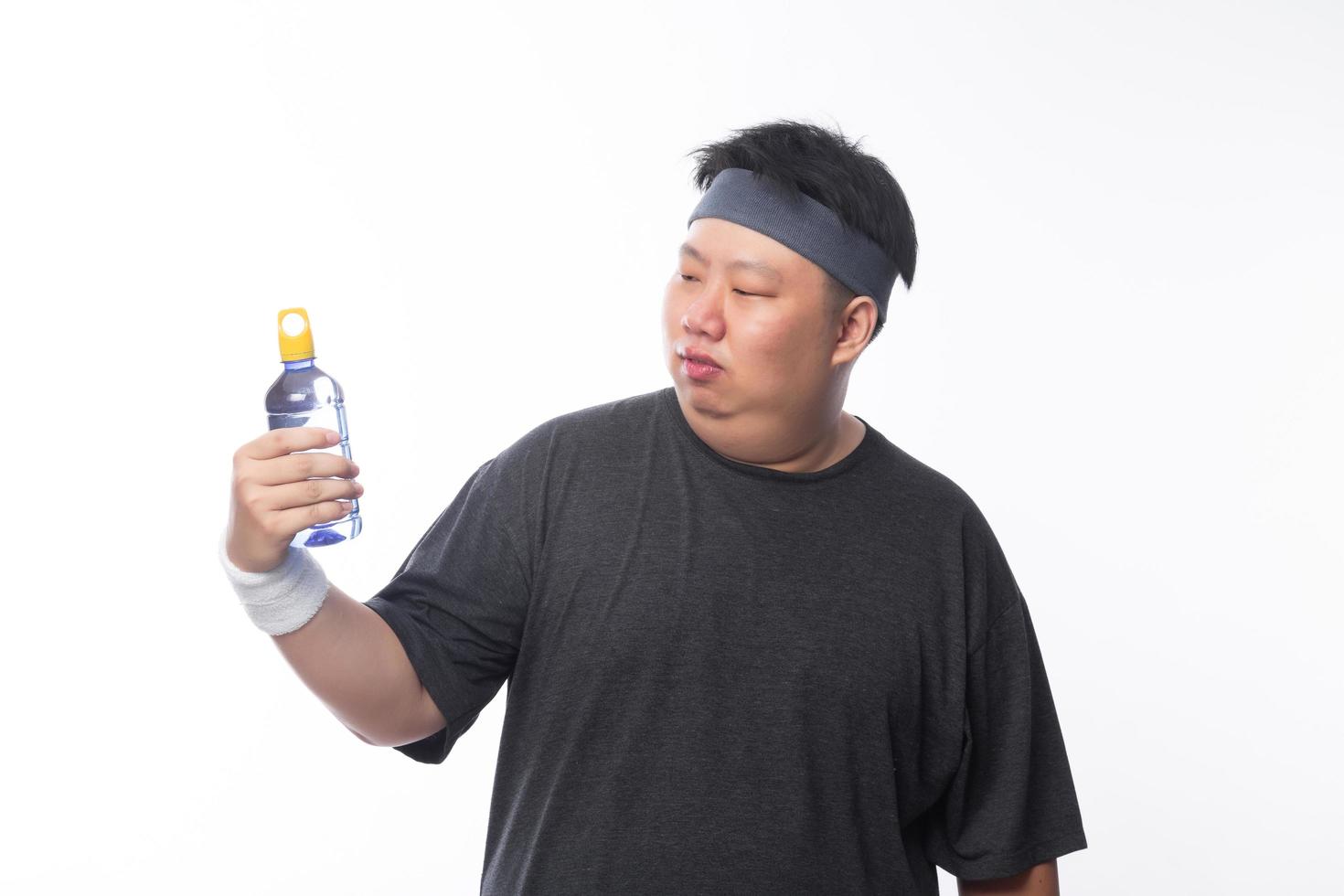 Asian funny fat sport man holding water bottle photo