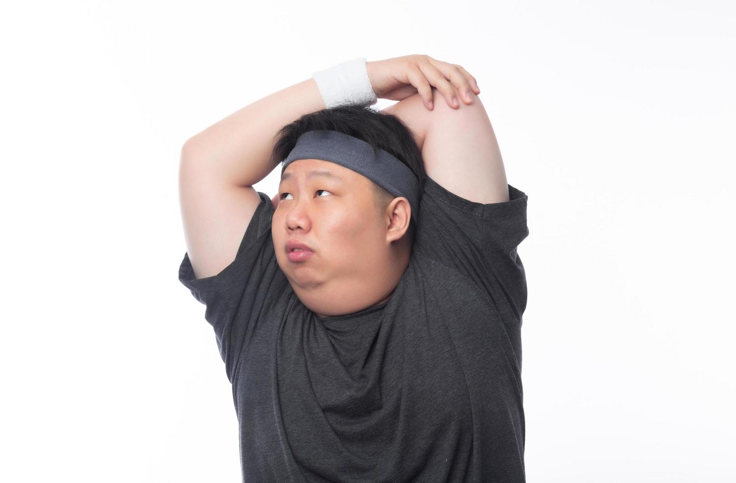 Young Asian funny fat sport man stretching before exercise photo