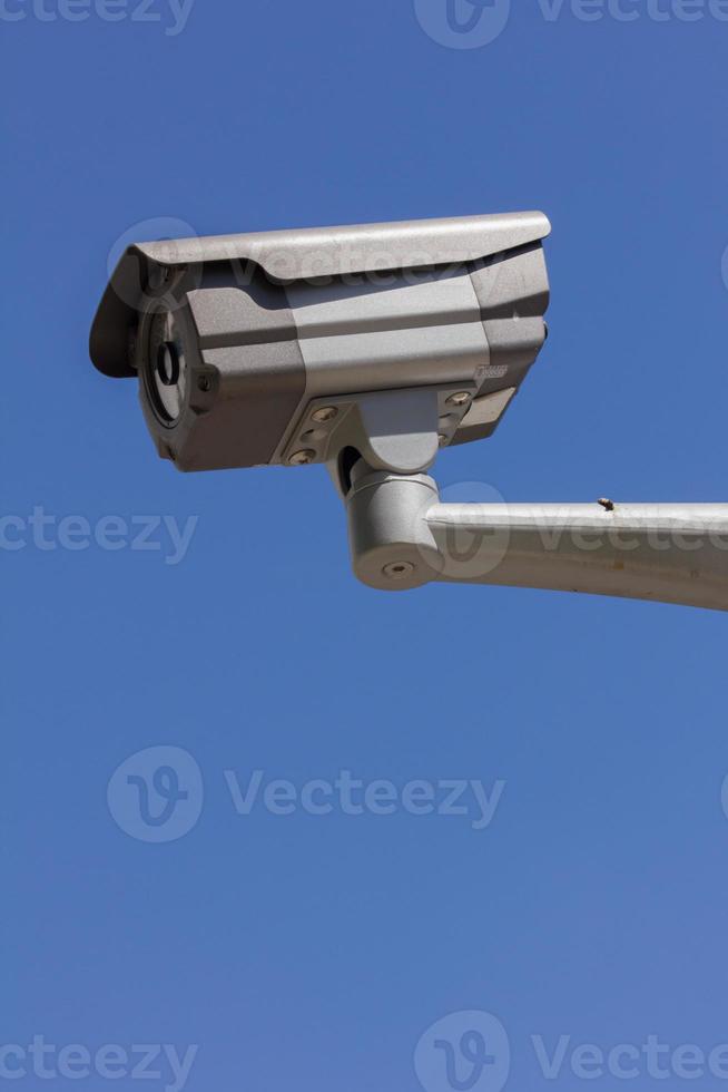 CCTV security camera, blue sky background photo