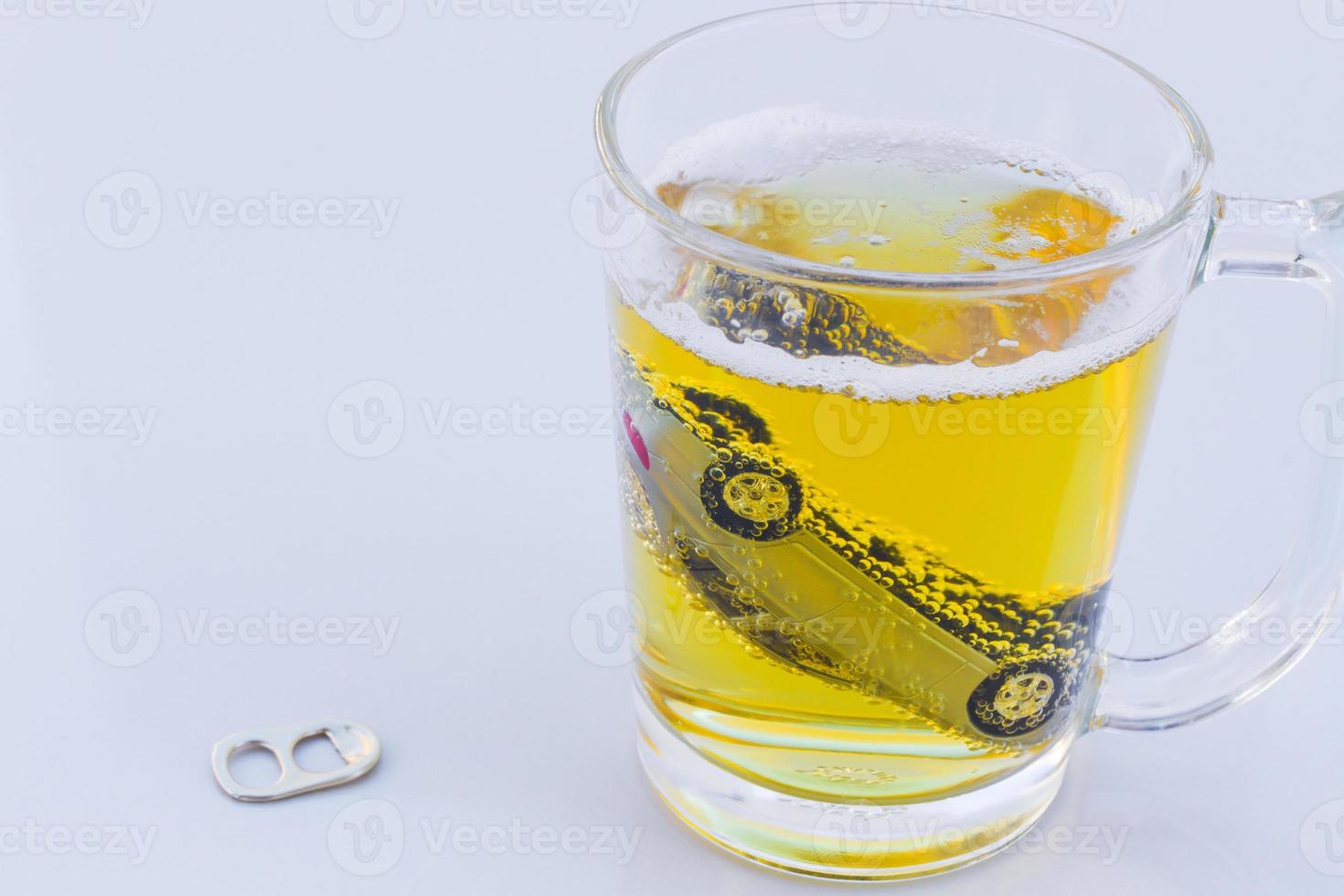 horizontal photo of toy car in a glass of beer isolated