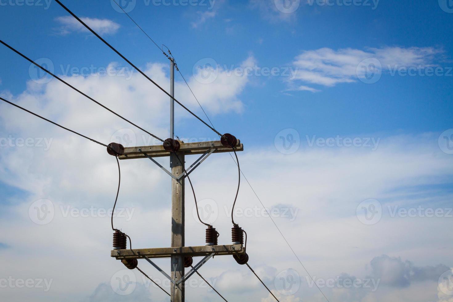 electrical post by the road with power line cables photo