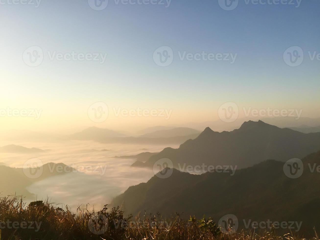 sunrise over the mist in phu chi fah mountain ,chiang rai , Thailand photo