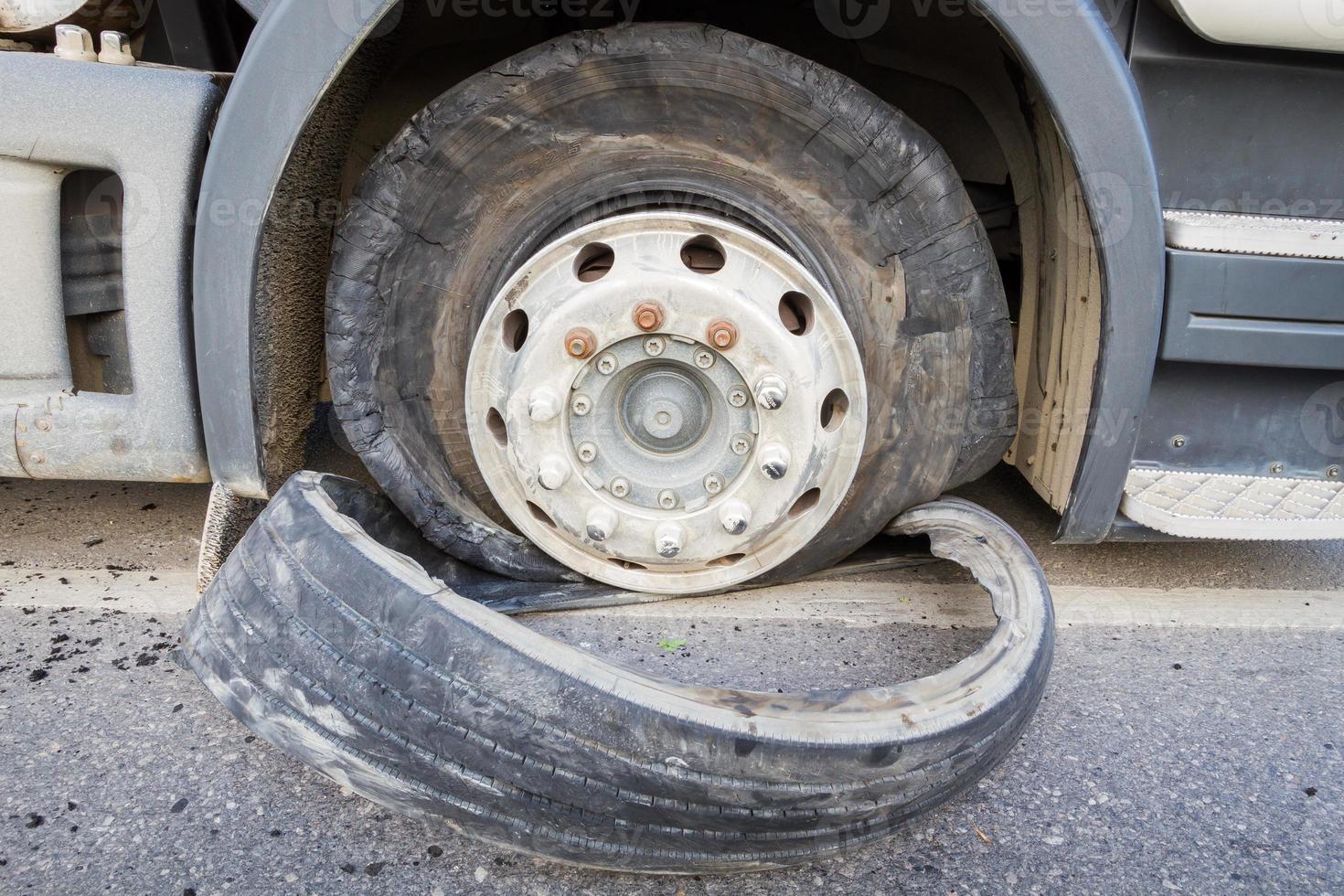 Damaged 18 wheeler semi truck burst tires by highway street photo