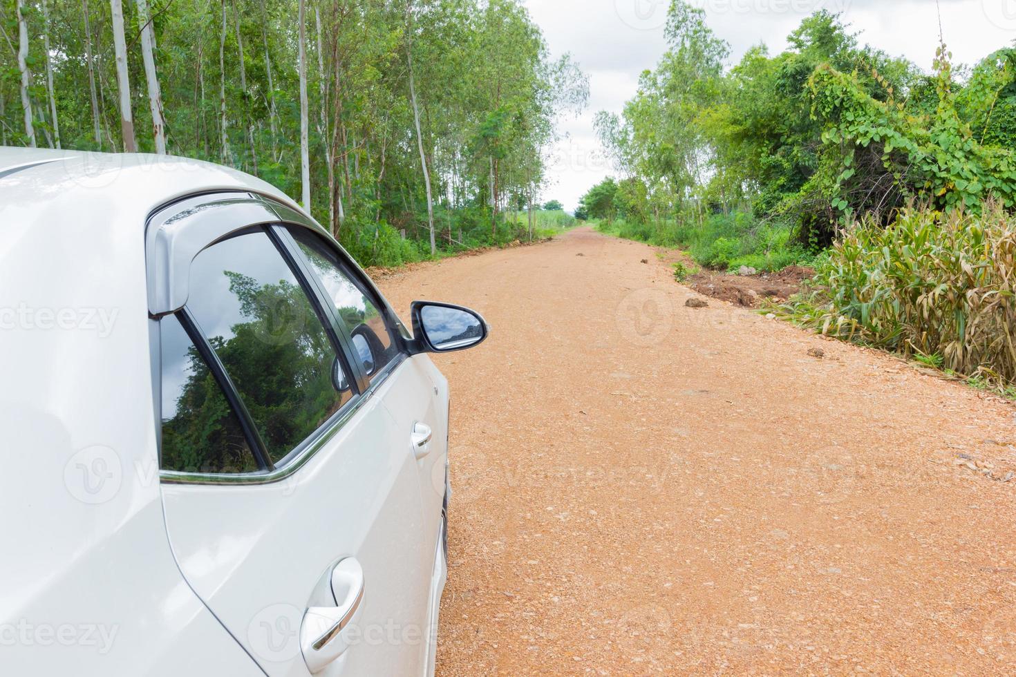 white car stop on the road on the dirt and gravel road photo