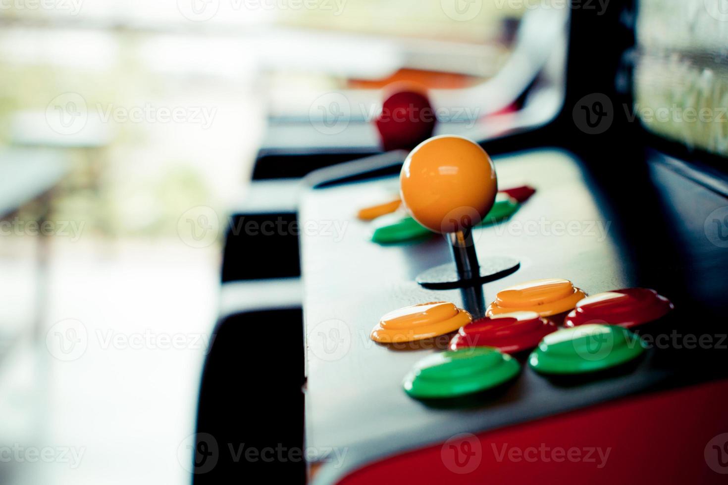 silhouette yellow joystick and six colorful button photo