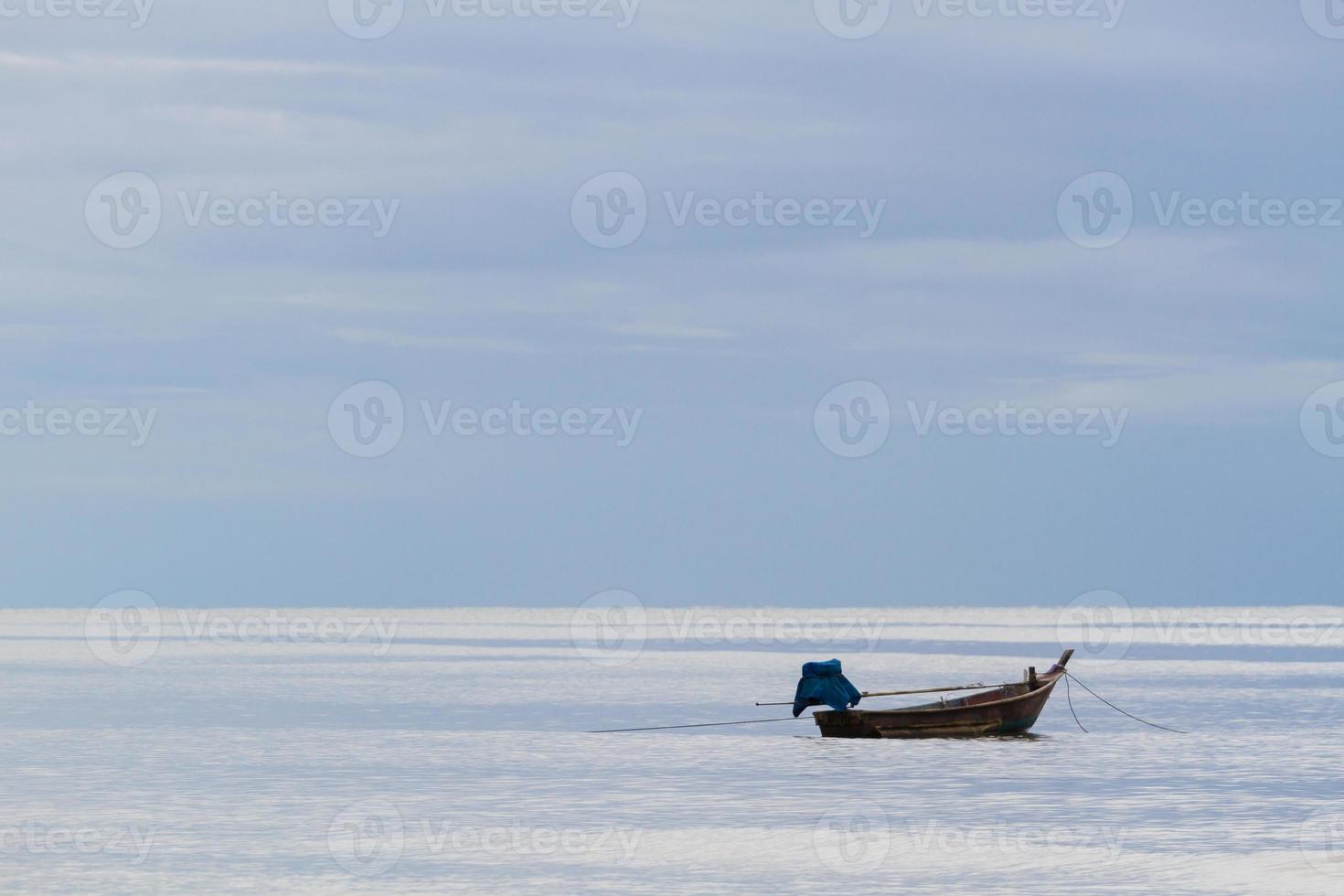 fishing boat floating on the sea background photo