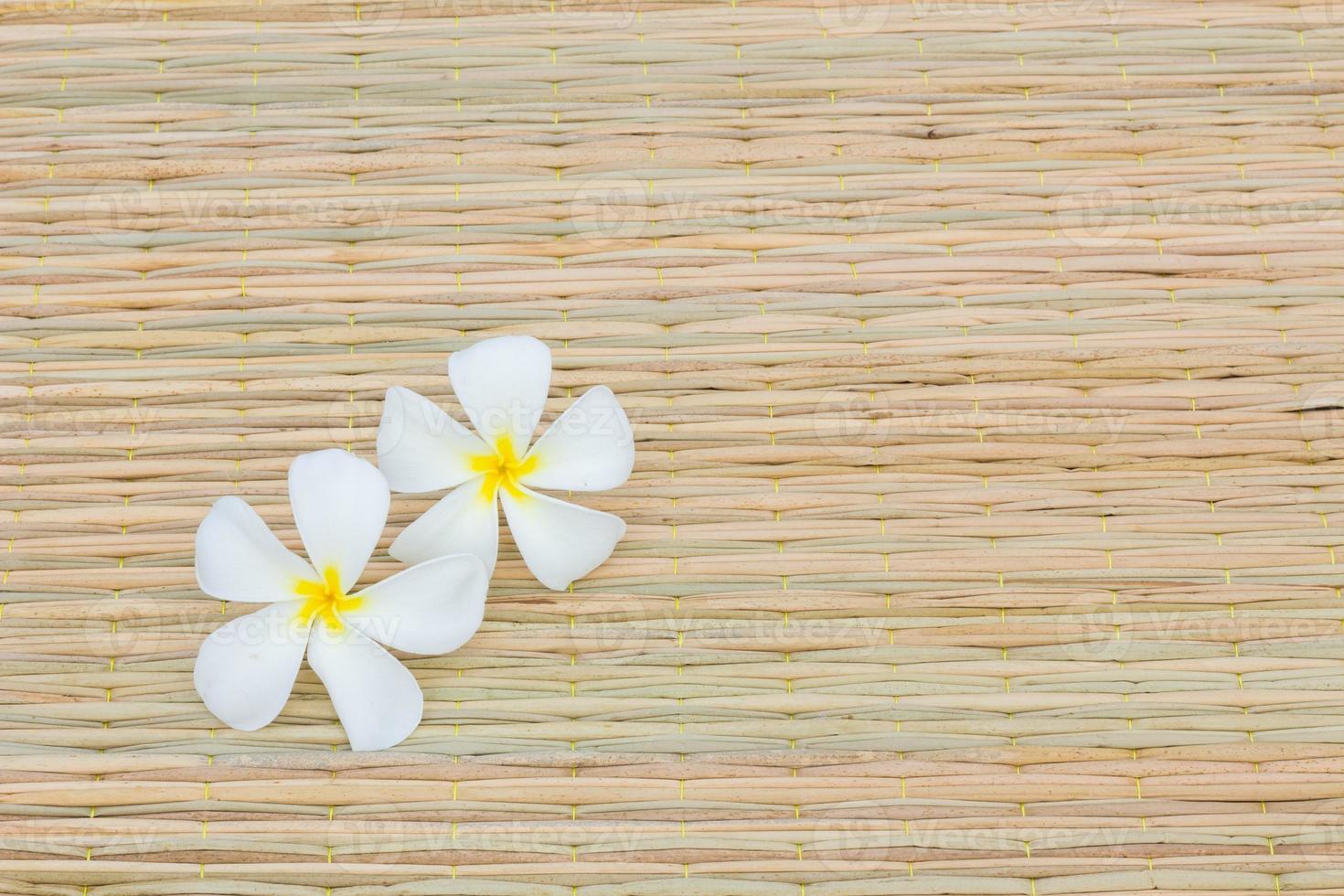 two White Plumeria on Thai traditional mat photo