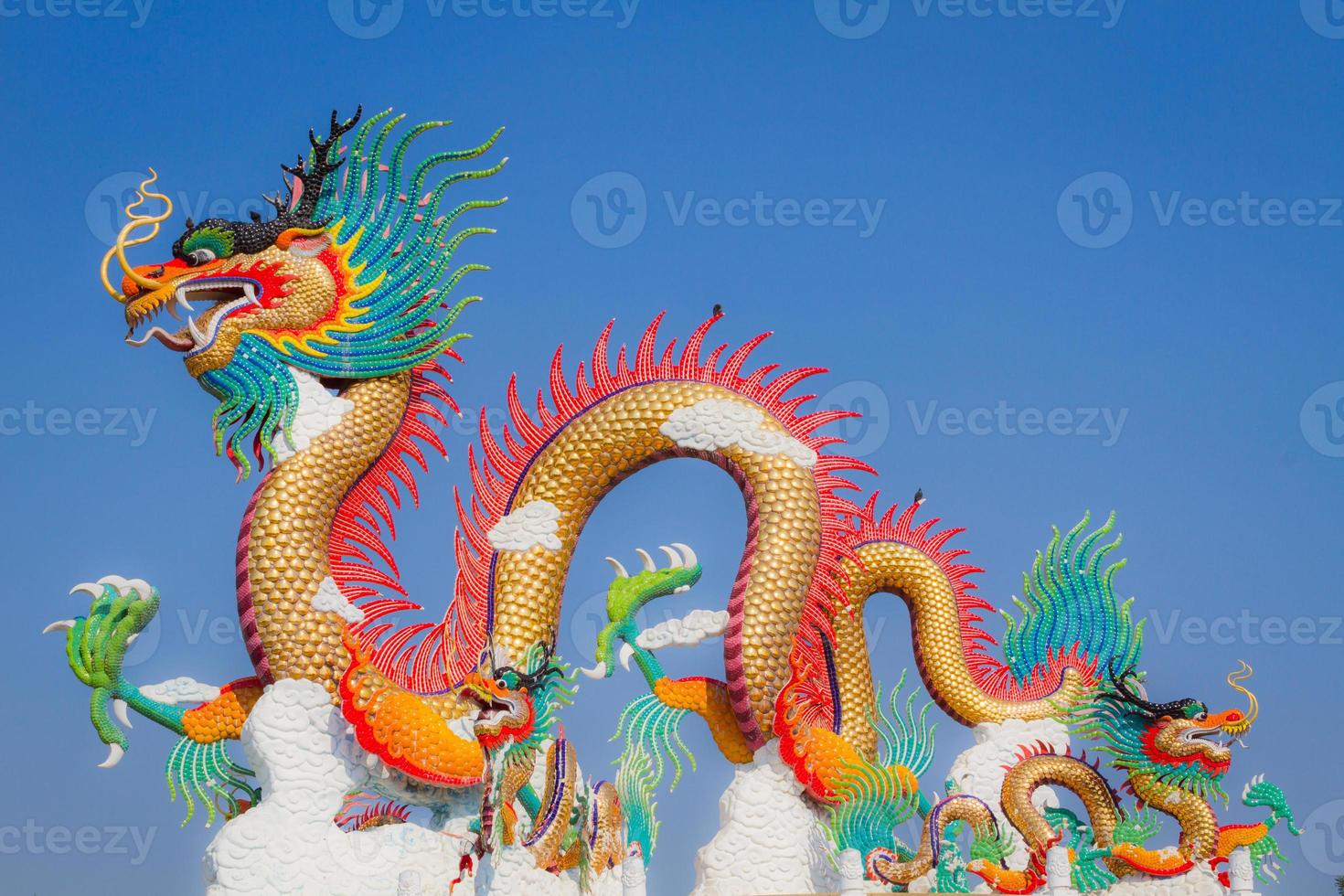 Chinese dragon statue with two small birds on its back photo