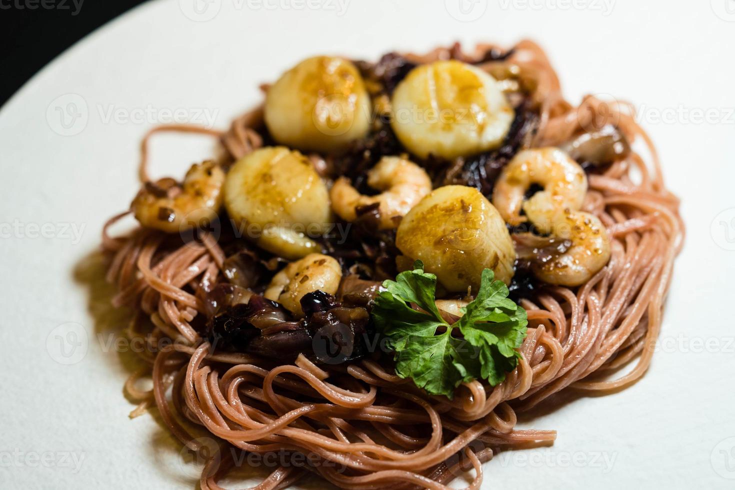 Scallops with red linguine pasta, herbs and spices photo