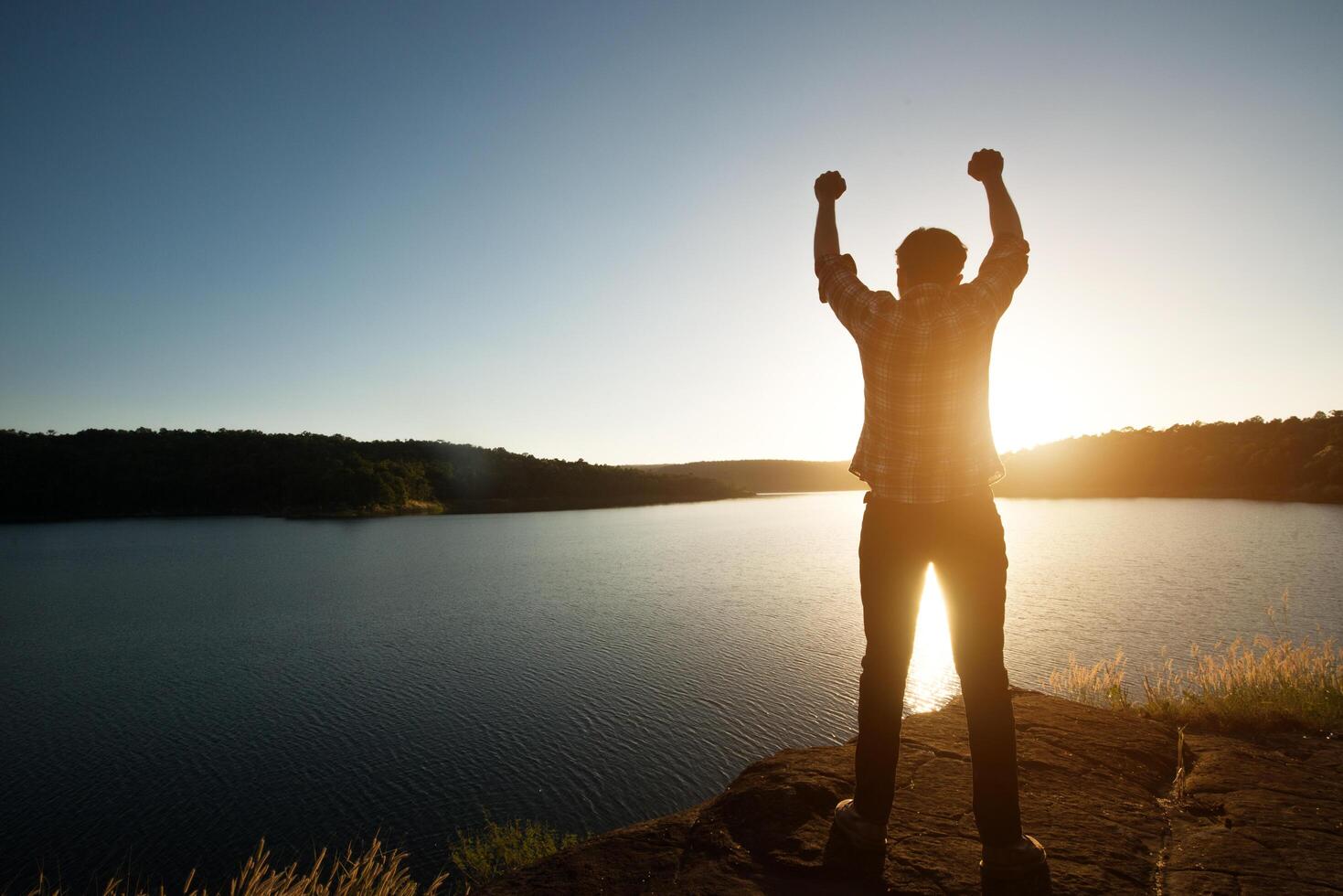 Hiker man winner silhouette on the mountain top.  Adventure life. photo