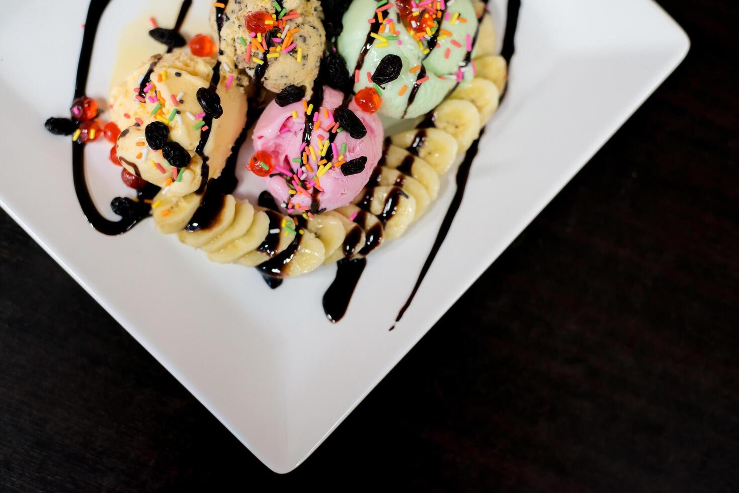 ice cream sundae vanilla strawberry chocolate lemon scoops with banana photo