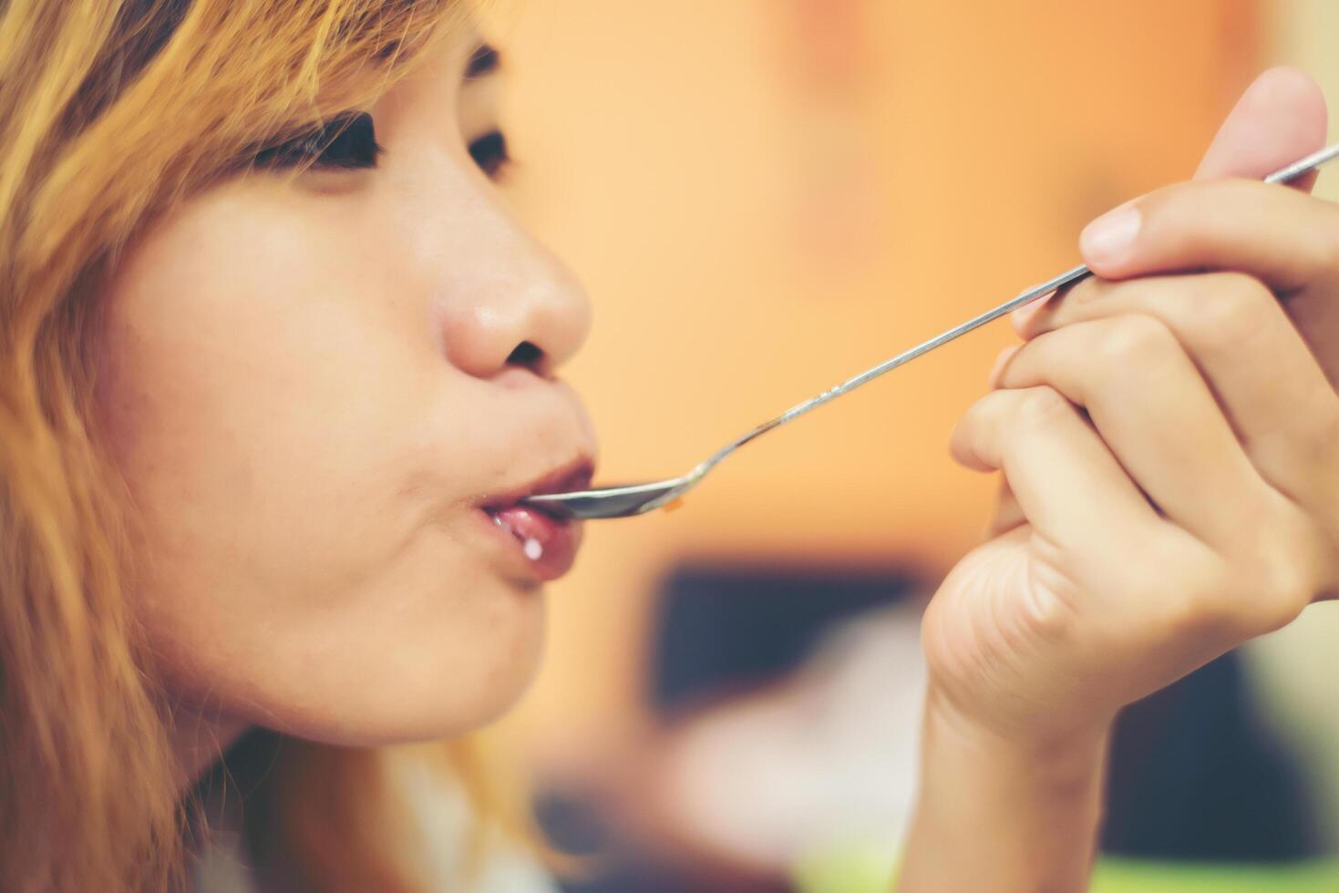 Young beautiful women enjoy eating with ice-cream sundae. photo