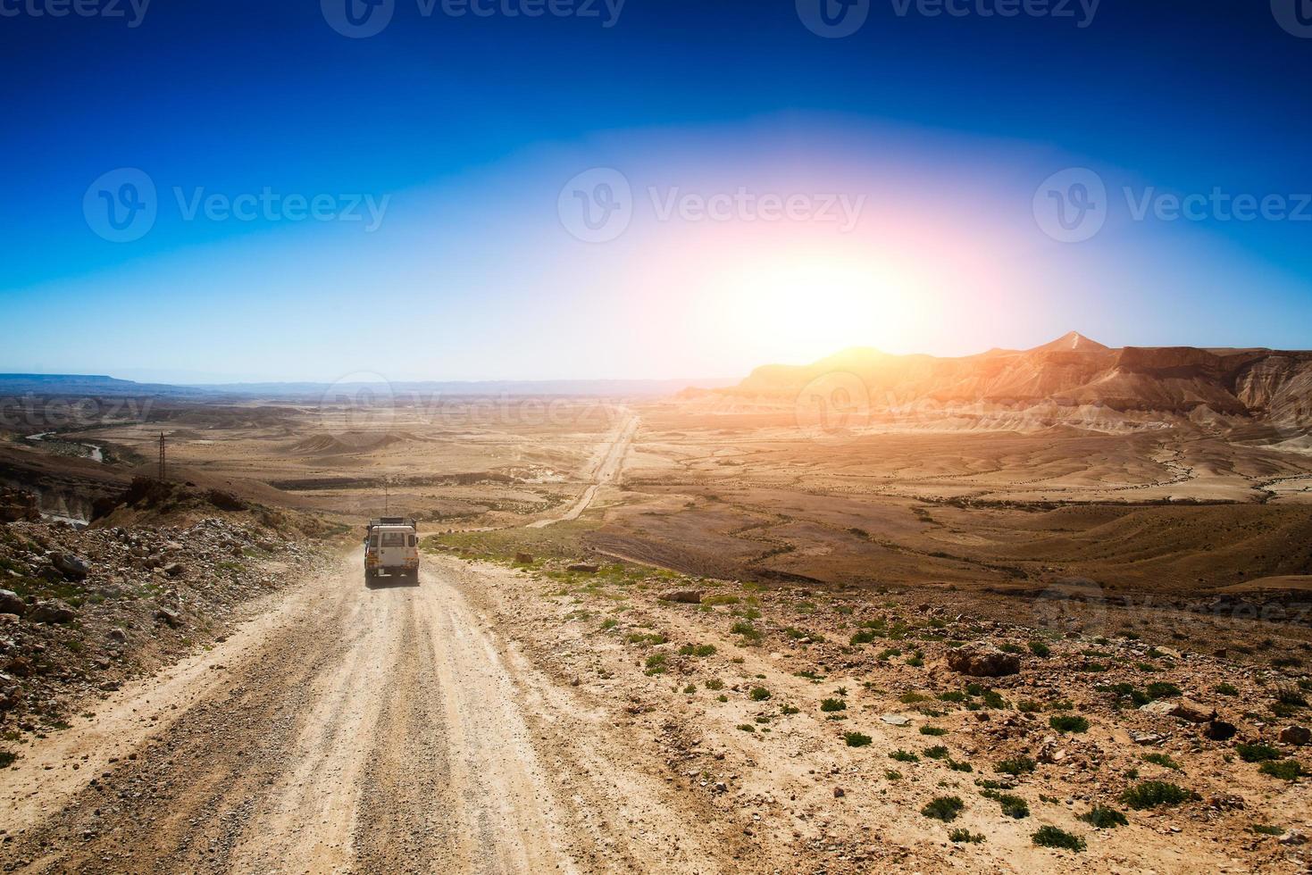 Jeep in a desert road photo