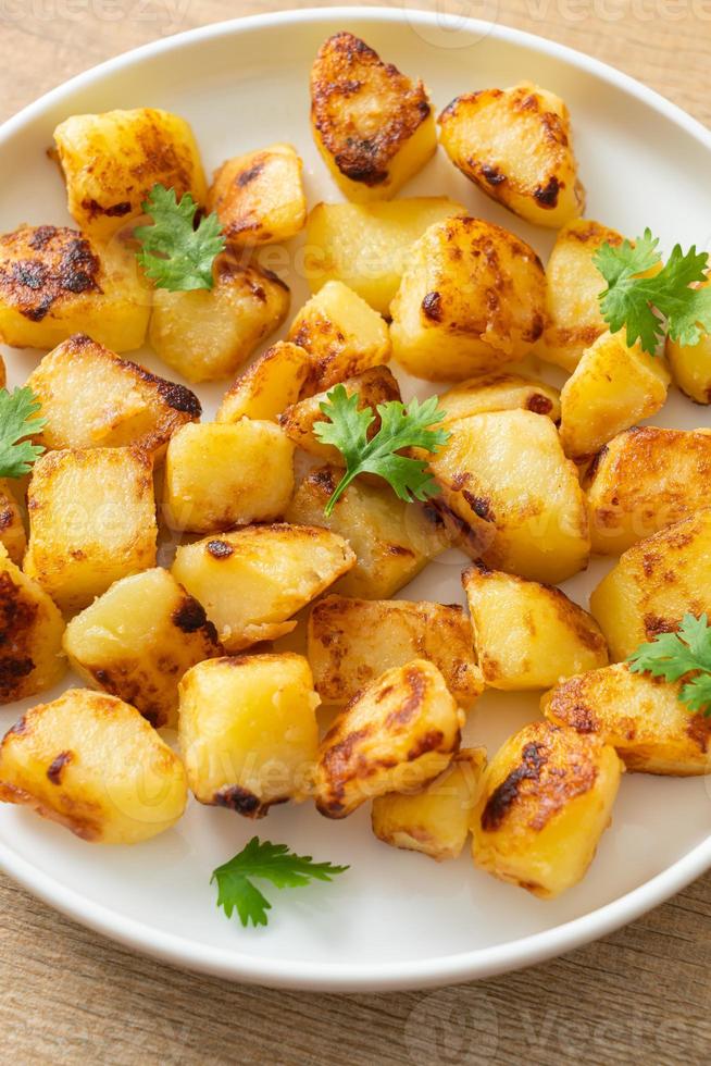 Roasted or grilled potatoes  on plate photo