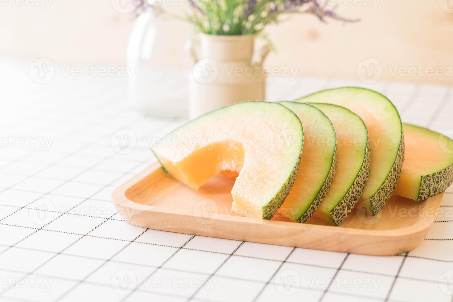 Fresh cantaloupe melon for dessert on table photo