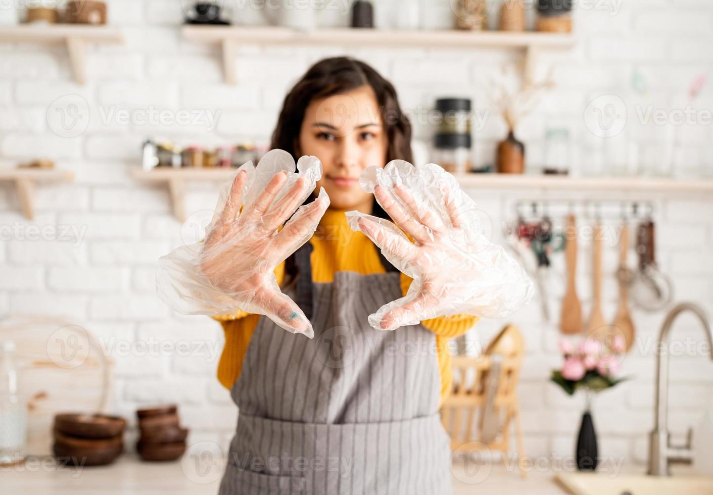 smiling woman preparing to color easter eggs in the kitchen photo