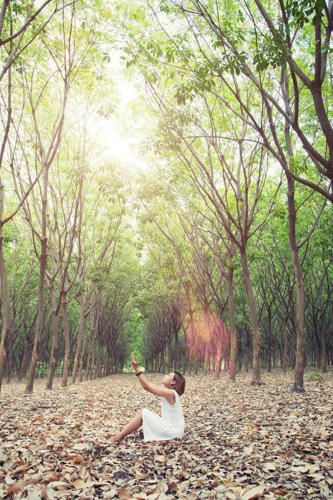 beautiful young woman pray for something in the green forest photo