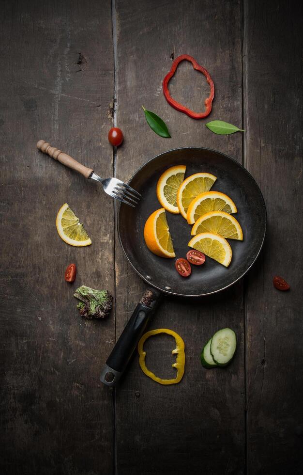 Fresh salad with slice of orange on a wooden background photo