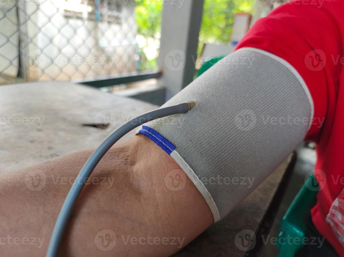 close-up asian fat woman measuring hypertension blood pressure photo