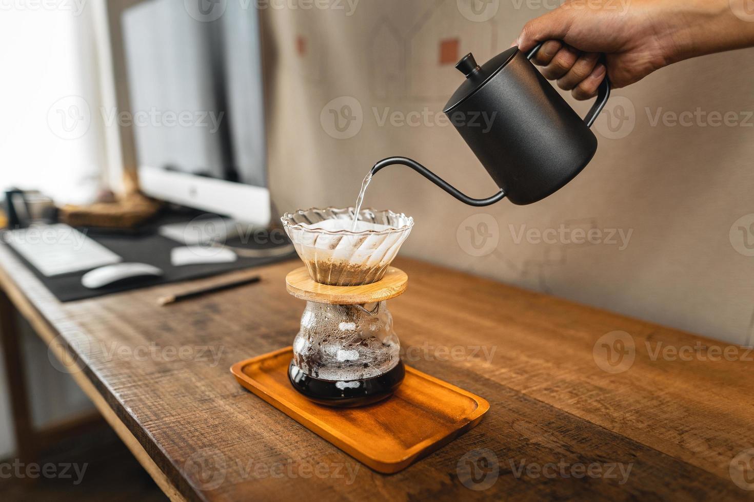 Pouring a hot water over a drip coffee photo