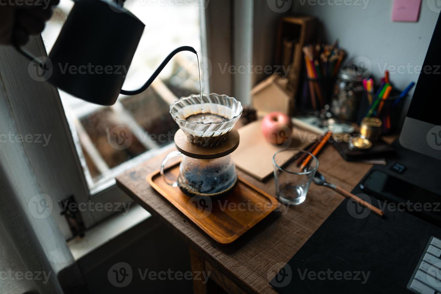 drip coffee in house,Pouring a hot water over a drip coffee photo