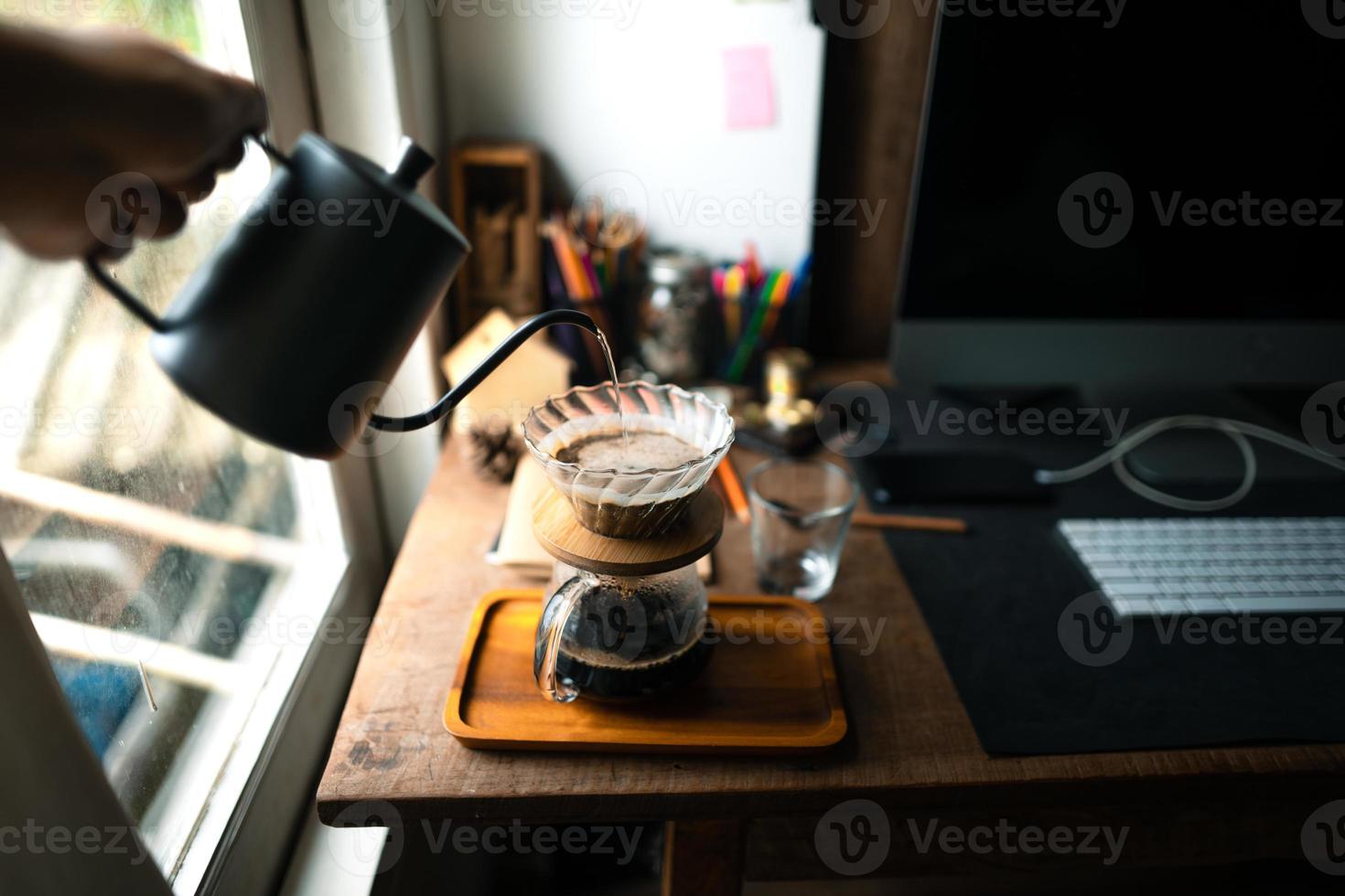 drip coffee in house,Pouring a hot water over a drip coffee photo