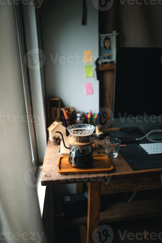 drip coffee in house,Pouring a hot water over a drip coffee photo