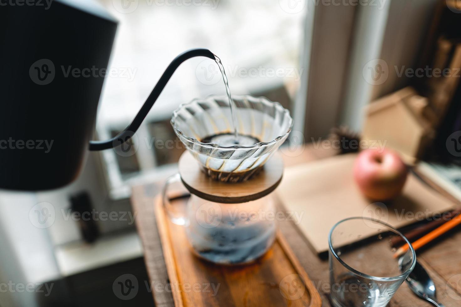 drip coffee in house,Pouring a hot water over a drip coffee photo
