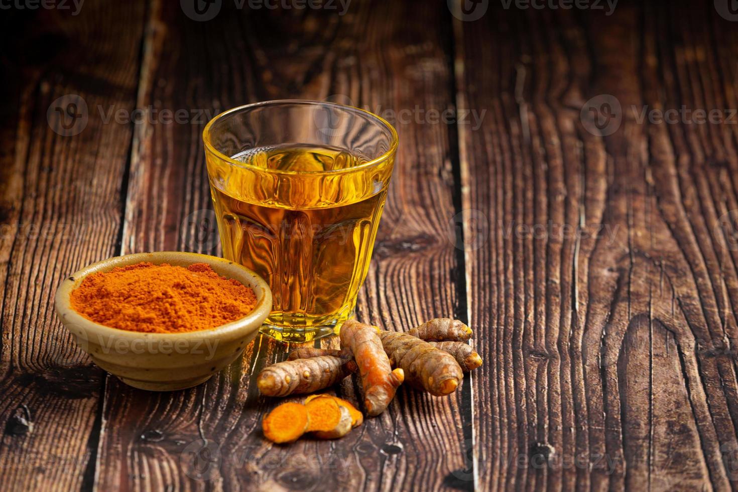 Turmeric juice and ground turmeric powder photo