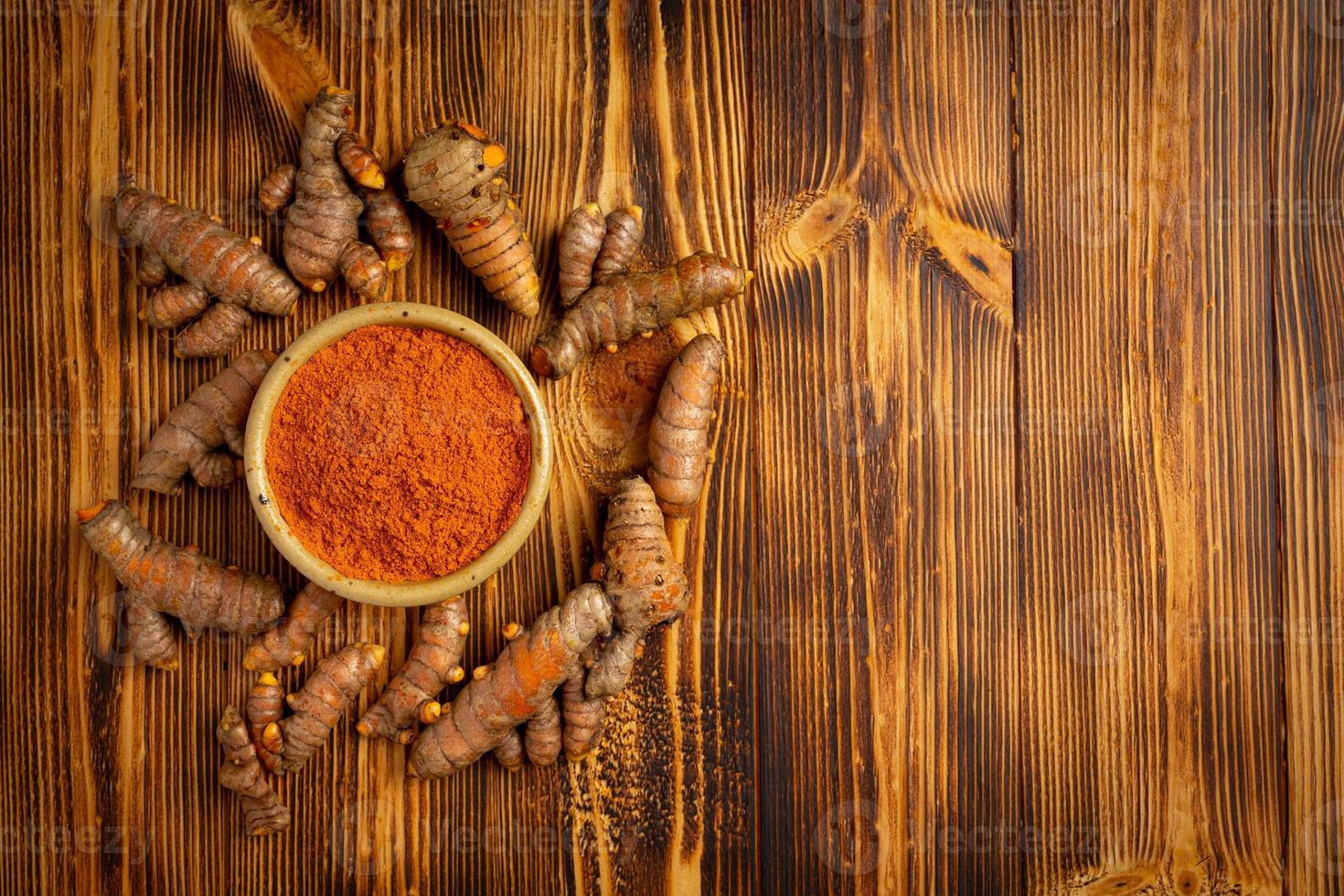 Tumeric rhizome with green leaf and turmeric powder photo