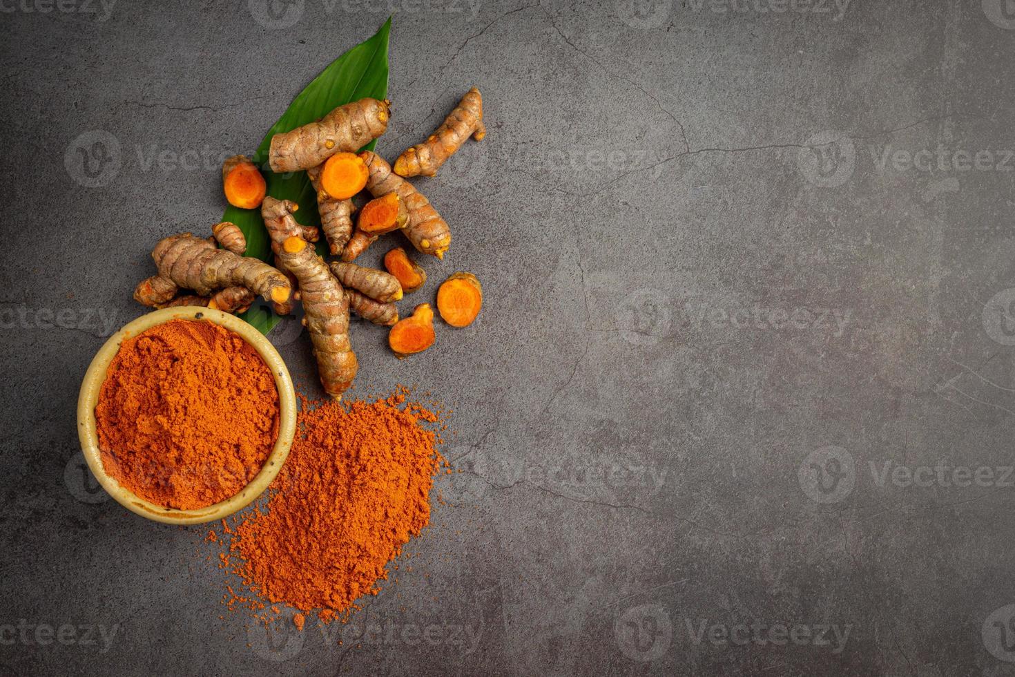 Tumeric rhizome with green leaf and turmeric powder photo