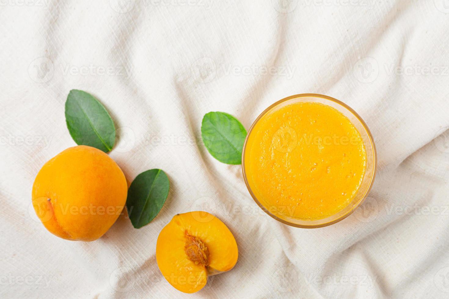 Peach juice is placed on a white cloth. photo