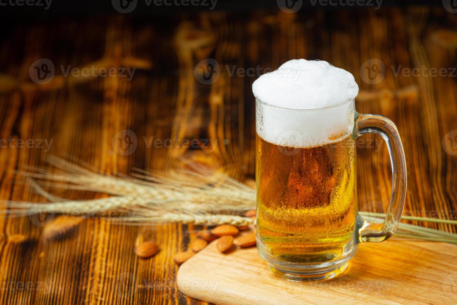 A glass of beer is placed on the wooden floor. photo