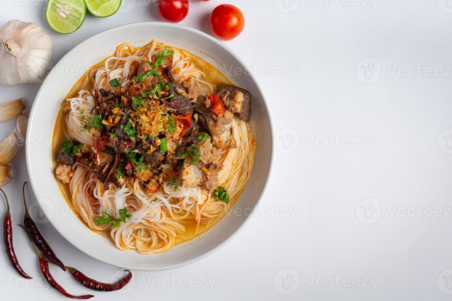 Rice noodles in fish curry sauce with vegetables photo