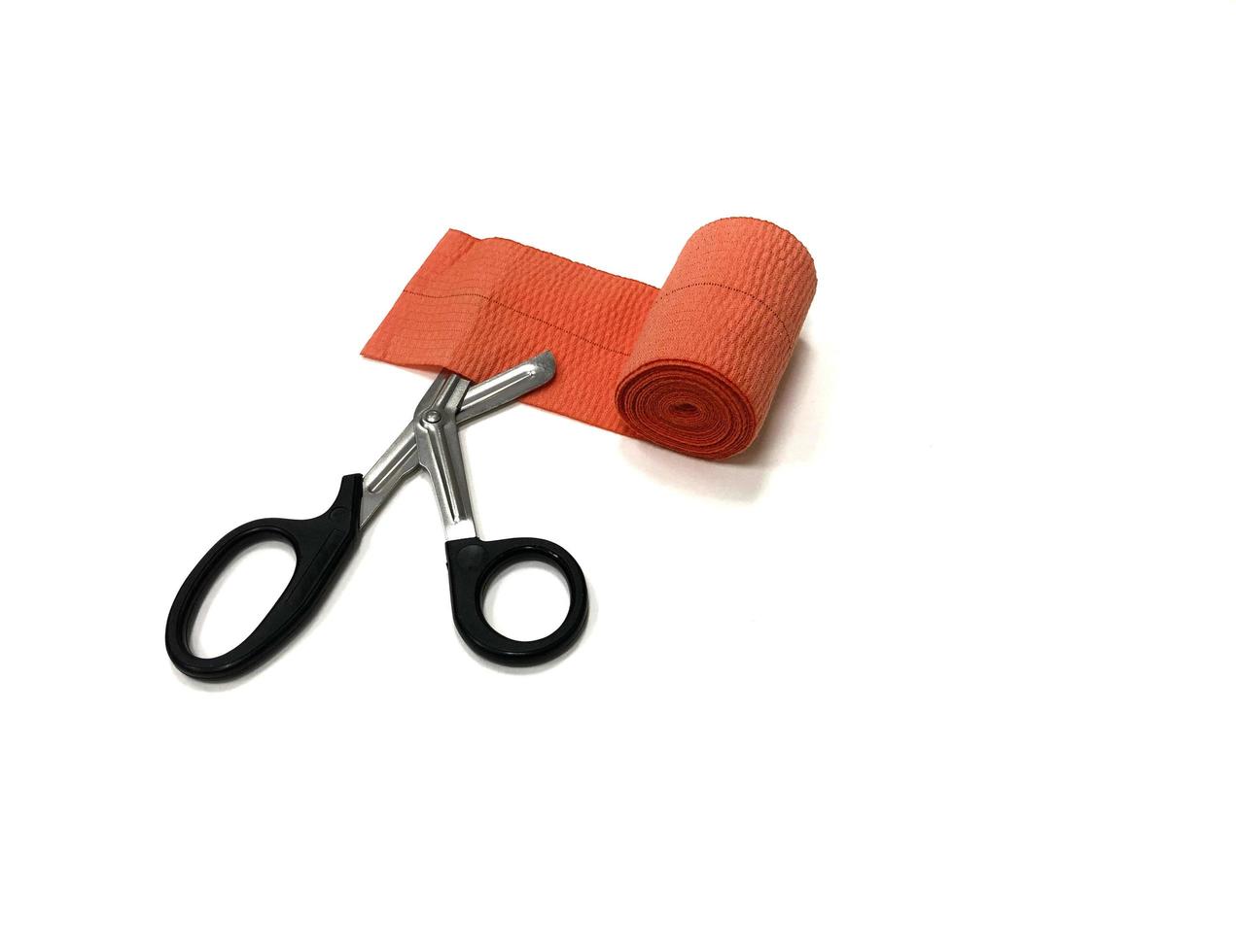 elastic bandage with black scissors on the white background, isolated photo