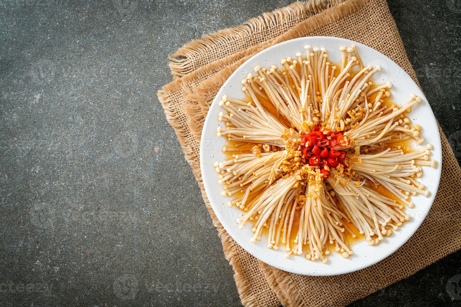 Homemade steamed golden needle mushroom or enokitake with soy sauce, chili, and garlic photo