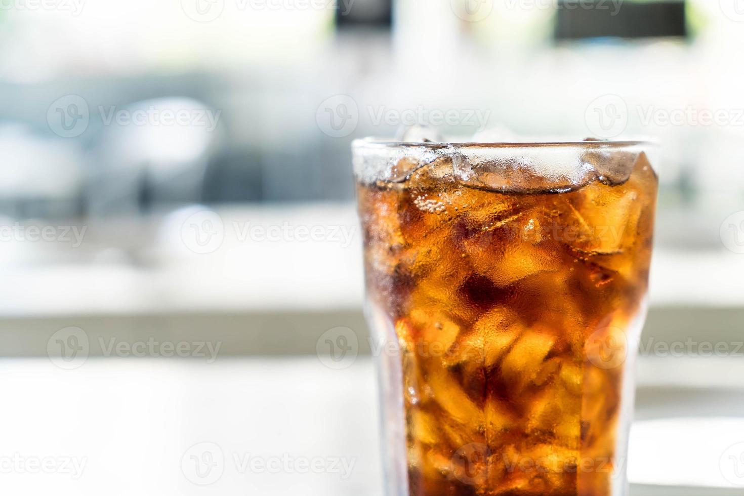 Iced cola glass on the table photo