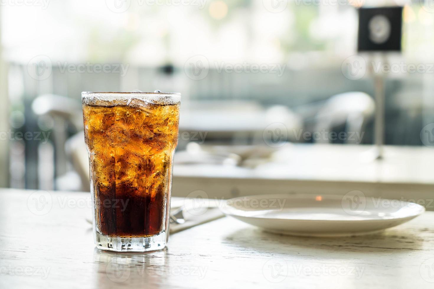 Iced cola glass on the table photo