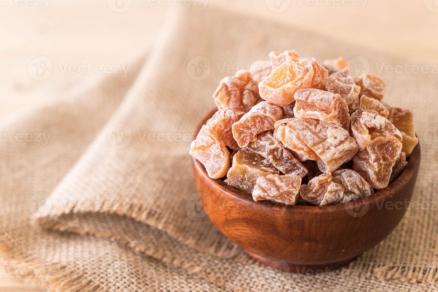 Dried plums in wood bowl photo