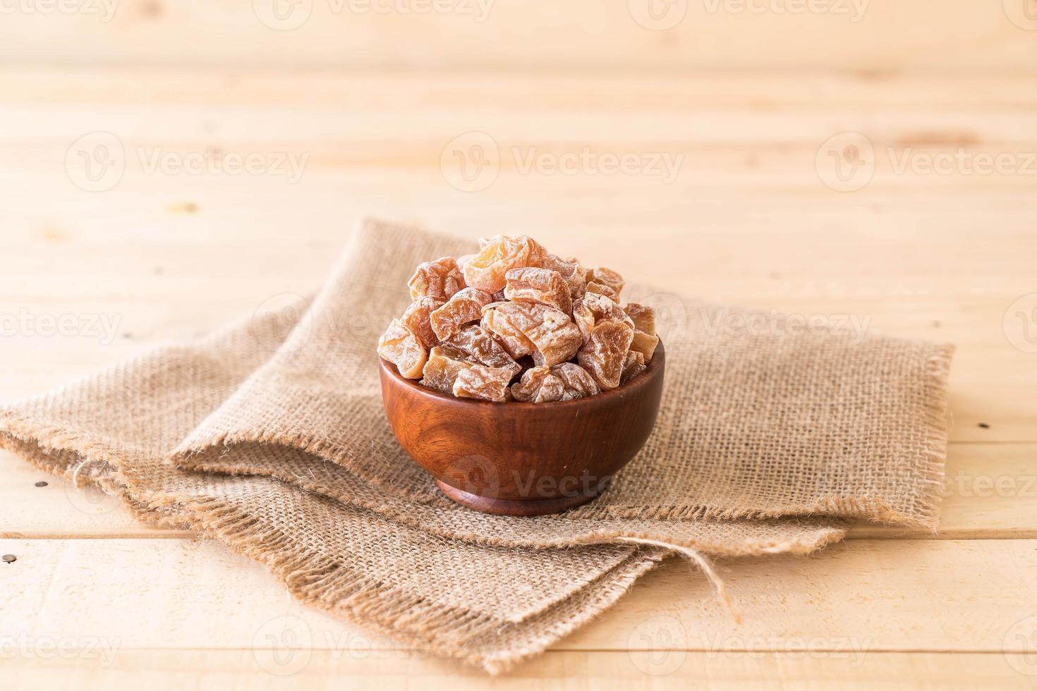 Dried plums in wood bowl photo