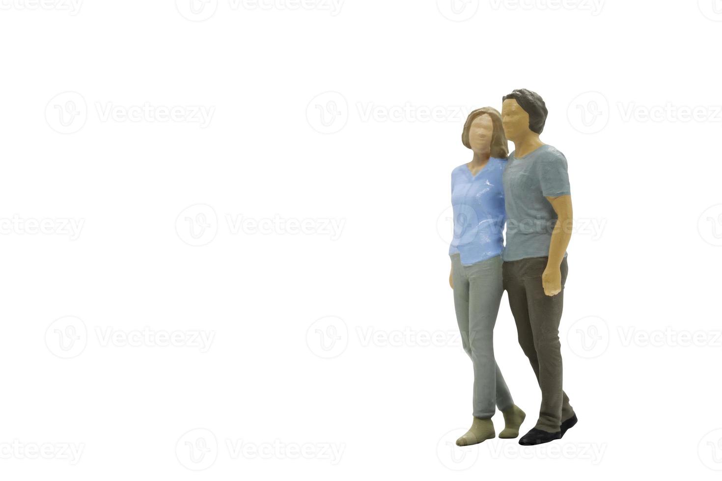 Miniature people couple standing together on white background photo